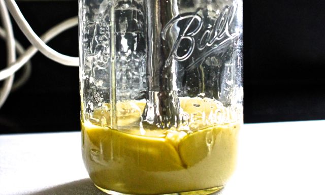 blending creamy dijon vinaigrette in a ball jar